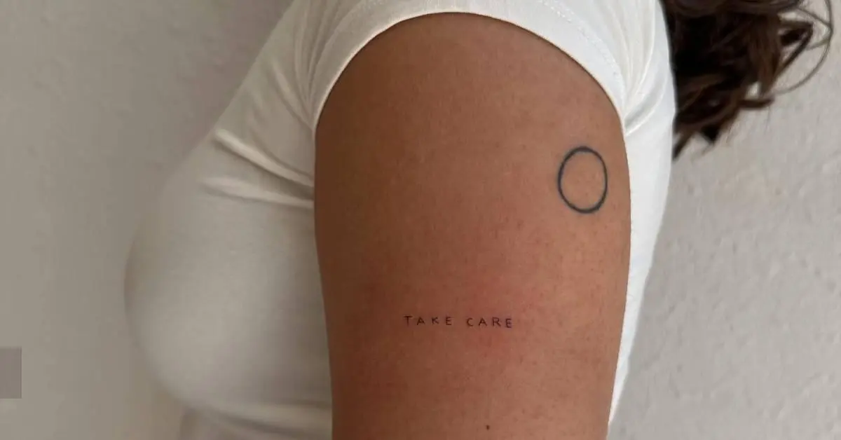 Tattoo that says "take care" lettering tattoo located
